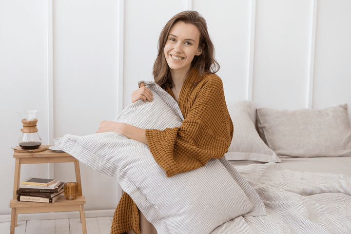 Stonewashed linen duvet cover and pillowcases in soft natural tones, styled in a Scandinavian-inspired bedroom.