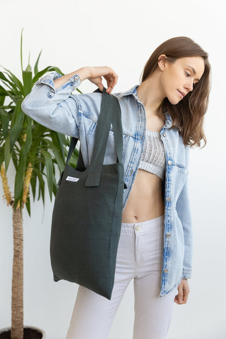 Handmade European linen tote bag in green, styled with fresh groceries for a chic and eco-friendly shopping look.